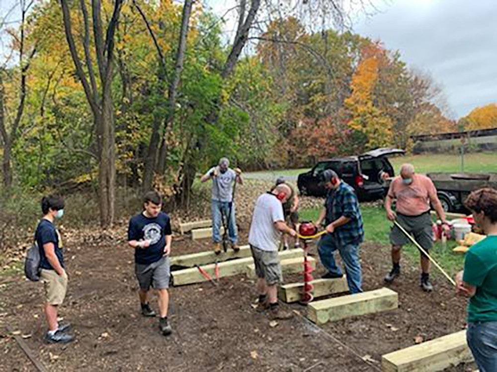 William Maier had a lot of help installing the park: L-R Basil Metz, Scout Maier, George Lopez, Robert Maier and Dan Flanagan at the auger, Steve Metz, Rich Ness and Andrew Richard. Those who also assisted but are not pictured: Peter Bellizzi, Abigail Maier, Beth Maier, Kyla Colon, Lenny Casabura, Luke Munson, Jared Grasseli, Frank Trezza, and [photographer] Ethan Thompson.
